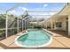Enjoy this screened-in kidney-shaped pool and spa at 7335 Saint Georges Way, University Park, FL 34201