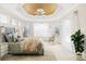 Main bedroom with tray ceiling, large windows, and room for seating at 7335 Saint Georges Way, University Park, FL 34201