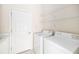 Clean laundry room, includes washer, dryer, and storage shelves at 7335 Saint Georges Way, University Park, FL 34201