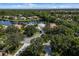 Luxury homes surround a tranquil lake, offering a serene waterfront lifestyle at 7335 Saint Georges Way, University Park, FL 34201
