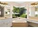 Bright bathroom featuring a corner bathtub and double vanities at 7335 Saint Georges Way, University Park, FL 34201
