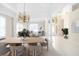Dining room with a modern table and chairs, looking towards entryway at 7335 Saint Georges Way, University Park, FL 34201