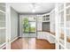 Bright home office features built-in shelving and wood flooring at 7335 Saint Georges Way, University Park, FL 34201