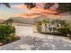 House exterior featuring a two-car garage and landscaping at 7335 Saint Georges Way, University Park, FL 34201