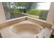 Relax in this oval jacuzzi tub with surrounding marble at 7335 Saint Georges Way, University Park, FL 34201