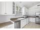 Bright kitchen with white cabinets, stainless steel appliances, and granite countertops at 7335 Saint Georges Way, University Park, FL 34201
