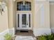 Front entry with decorative glass door and sidelights at 7335 Saint Georges Way, University Park, FL 34201