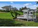 Landscaped area with gazebo and pergola over a pond at 7335 Saint Georges Way, University Park, FL 34201