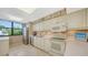 White kitchen with stainless steel appliances and ample counter space at 826 Bayport Way # 826, Longboat Key, FL 34228
