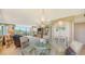 Elegant dining room with a glass-top table and chandelier at 826 Bayport Way # 826, Longboat Key, FL 34228