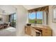 Home office with built-in desk and window overlooking nature at 826 Bayport Way # 826, Longboat Key, FL 34228
