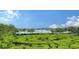 Lush green landscape with scenic water view in background at 826 Bayport Way # 826, Longboat Key, FL 34228