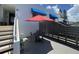 Private patio with table, chairs and red umbrella at 826 Bayport Way # 826, Longboat Key, FL 34228