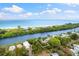 Aerial view of waterfront property with canal access and ocean views at 8016 Midnight Pass Rd, Sarasota, FL 34242