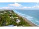 Beachfront property aerial view, showcasing the home and ocean at 8016 Midnight Pass Rd, Sarasota, FL 34242