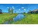 Scenic aerial view of a community waterway surrounded by lush greenery and blue skies, offering serene vistas at 109 Corserra Dr, Nokomis, FL 34275