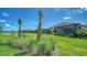 Expansive backyard featuring manicured lawns and lush landscaping with view of neighboring homes at 109 Corserra Dr, Nokomis, FL 34275