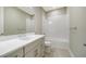 Clean bathroom featuring tile flooring, white vanity, and a tub-shower combination with tiled walls at 109 Corserra Dr, Nokomis, FL 34275