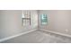 Neutral bedroom features plush carpet, windows for natural light, and neutral paint at 109 Corserra Dr, Nokomis, FL 34275