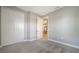 Cozy bedroom with plush carpeting, walk-in closet, and view into another room at 109 Corserra Dr, Nokomis, FL 34275