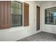 Covered front entry porch with craftsman door, sidelight, and window with decorative shutters at 109 Corserra Dr, Nokomis, FL 34275