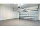 Spacious garage with epoxy flooring and an insulated garage door, offering a clean and durable space at 109 Corserra Dr, Nokomis, FL 34275