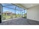 Screened lanai with brick flooring overlooking a tranquil lake and backyard at 109 Corserra Dr, Nokomis, FL 34275