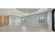 Spacious living room with tile floors, two windows, and a view of the backyard at 109 Corserra Dr, Nokomis, FL 34275