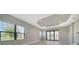 Bright living room boasts large windows, recessed lighting, and sliding glass doors leading outside at 109 Corserra Dr, Nokomis, FL 34275
