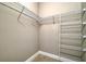 Walk-in closet showcases tile flooring, metal shelving, and ample storage space at 109 Corserra Dr, Nokomis, FL 34275