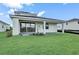 Home with covered patio and grassy backyard at 12926 Pinnacle Ln, Venice, FL 34293