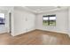 Spacious bedroom with hardwood floors and large window at 12926 Pinnacle Ln, Venice, FL 34293