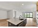 Modern kitchen with island, sink, and sliding glass doors to backyard at 12926 Pinnacle Ln, Venice, FL 34293