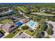 Community pool and clubhouse with surrounding landscape at 13791 Palmetto Point Ct, Port Charlotte, FL 33953