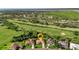 Bird's eye view of a house near a golf course and lake at 13791 Palmetto Point Ct, Port Charlotte, FL 33953
