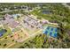 Aerial view of community amenities including tennis courts, pickleball courts, pool, and clubhouse at 13791 Palmetto Point Ct, Port Charlotte, FL 33953