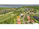An aerial view shows the property's location in a golf community near a lake at 13791 Palmetto Point Ct, Port Charlotte, FL 33953