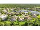 An aerial view shows homes surrounding a pond within a golf course community at 13791 Palmetto Point Ct, Port Charlotte, FL 33953