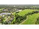 Aerial view showcasing a golf course community with mature trees and waterway views at 13791 Palmetto Point Ct, Port Charlotte, FL 33953