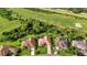 Aerial view of homes in a golf course community with well-kept lawns and mature trees at 13791 Palmetto Point Ct, Port Charlotte, FL 33953