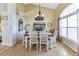 Elegant dining room with a charming chandelier, a dining table set for six, and bright natural light at 13791 Palmetto Point Ct, Port Charlotte, FL 33953