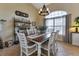 Bright dining room featuring a farmhouse table and window seating at 13791 Palmetto Point Ct, Port Charlotte, FL 33953