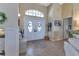 Bright and welcoming foyer featuring a tiled floor, a decorative rug, and a charming bench for seating at 13791 Palmetto Point Ct, Port Charlotte, FL 33953