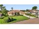 Attractive single-story home with a tile roof, an expansive green lawn, and well-maintained landscaping at 13791 Palmetto Point Ct, Port Charlotte, FL 33953