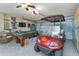 Garage with pool table, golf cart, and storage at 13791 Palmetto Point Ct, Port Charlotte, FL 33953