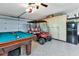 Finished garage with golf cart, pool table, storage cabinets, and refrigerator at 13791 Palmetto Point Ct, Port Charlotte, FL 33953