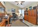 Home office features two desks, comfortable chair, and storage cabinets at 13791 Palmetto Point Ct, Port Charlotte, FL 33953