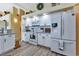 Well-lit kitchen featuring stainless steel appliances, white cabinetry, granite countertops, and modern fixtures at 13791 Palmetto Point Ct, Port Charlotte, FL 33953