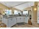 Bright kitchen with granite countertops, stainless steel dishwasher, modern cabinetry and stylish hardwood floors at 13791 Palmetto Point Ct, Port Charlotte, FL 33953