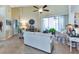Cozy living room with tiled floors, neutral decor, and a sliding glass door providing a view of the outdoor space at 13791 Palmetto Point Ct, Port Charlotte, FL 33953
